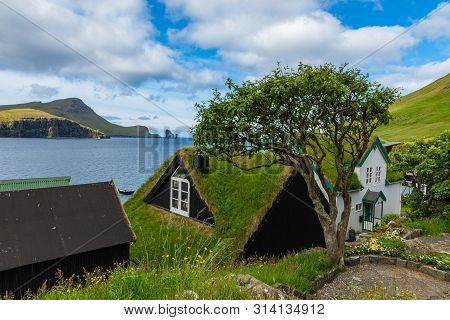 Bour Village. Typical Grass-roof Houses And Green Mountains. Vagar Island, Faroe Islands. Denmark. E