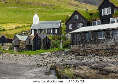 Bour Village. Typical Grass-roof Houses And Green Mountains. Vagar Island, Faroe Islands. Denmark. E