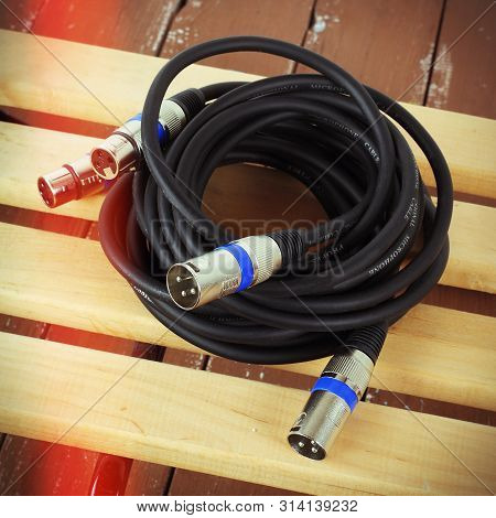 Music And Sound - Xlr Microphone Cable Professional On A Wooden Background.