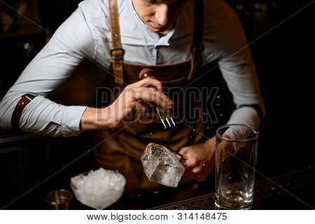 Bartender Crushes Piece Of Ice With Crusher