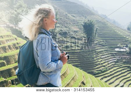 Young Caucasian Blonde Woman In Denim Shirt Taking Pictures Of Sapa Rice Terraces At Sunset In Lao C