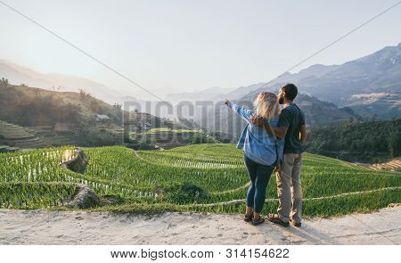 Young Caucasian Couple Overlooking Rice Terraces Of Sapa At Sunset In Lao Cai Region Of Vietnam