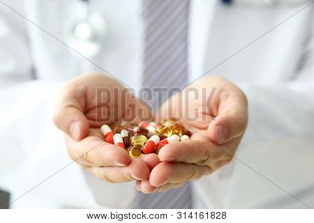 Gp Holding In Arms Heap Pf Different Pills Close-up. Illness Prevention Life Save And Emergency Case