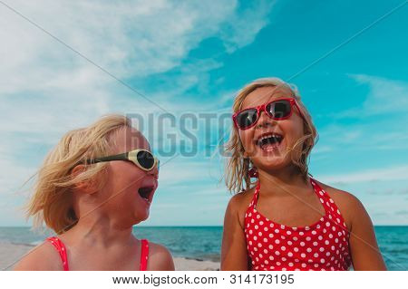 Happy Cute Little Sisiters Enjoy Summer Beach