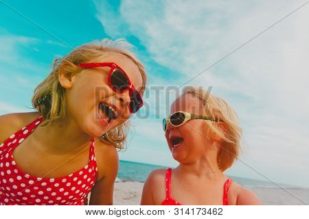 Happy Cute Little Sisiters Enjoy Summer Beach
