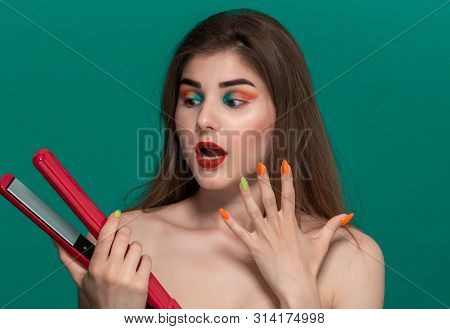 Portrait Of Beautiful Young Woman With Bright Color Make-up Doing Hair Style Herself With A Purple S