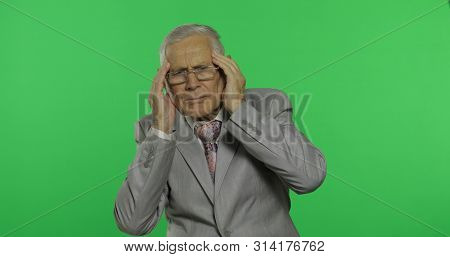 Elderly Businessman In Suit Suffer By Headache Pain Trouble. Old Senior Man In Formal Wear On Chroma