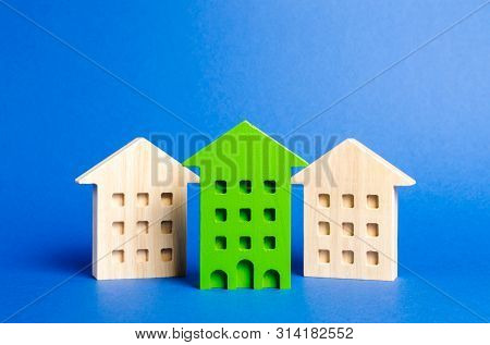 Green Figure Of A Residential Building Stands Out Among The Rest Of The Houses. Search For The Best 