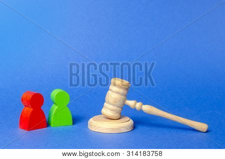 Two Figures Of People Opponents Stand Near The Judge's Gavel. The Judicial System. Court Case, Settl