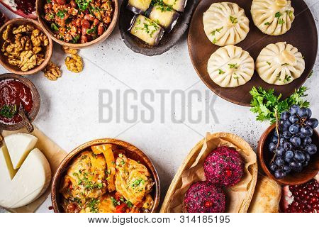Traditional Georgian Cuisine Background. Khinkali, Phali, Chahokhbili, Lobio, Cheese, Eggplant Rolls