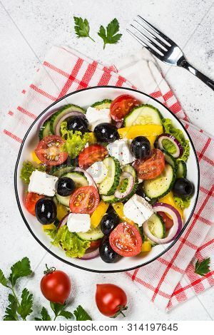 Greek Salad. Vegetable Salad With Tomato, Cucumber, Salad Leaves, Feta Cheese And Olive Oil. Top Vie