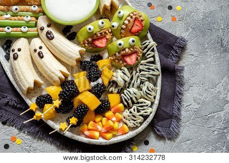 Healthy Fruit Halloween Treats. Banana Ghosts, Clementine Orange Pumpkins And Apple Monster Mounts