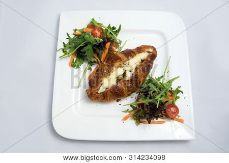 A Low Contrast Hero Shot Of A Breakfast Platter With Cheese And Zaatar Filled Croissant With Vegetab