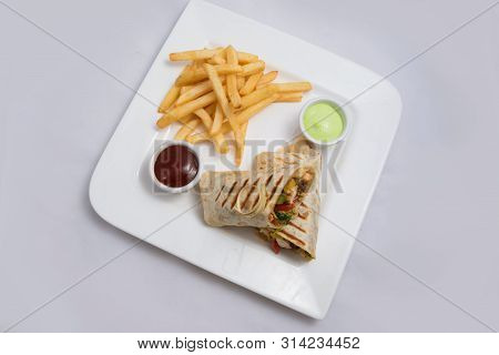 A Low Contrast Hero Shot Of A Chicken Pimiento Sandwich With Samurai & Alger Sauce & Fries On The Si
