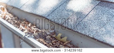 Panoramic Gutter Clogged By Dried Leaves And Messy Dirt Need Clean-up
