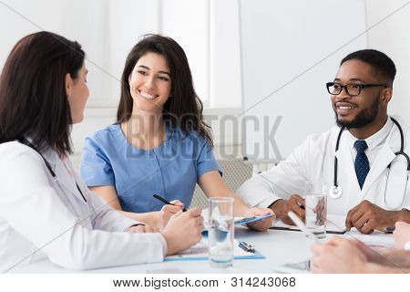 Medical Meeting. Intern With Mentor Talking And Discussing Questions At Hospital