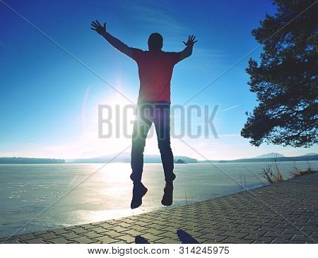 Tall Man Jamping By Sea On The Beach. Powerful Runner Training Outdoor In Cold Spring Morning. Hot S