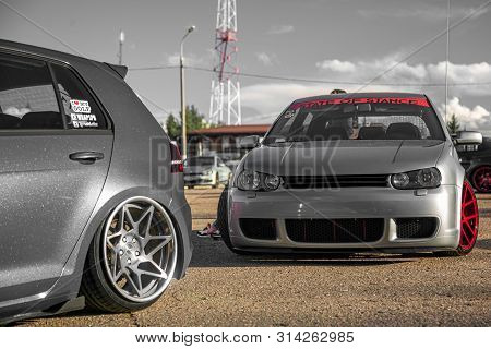 Moscow, Russia - July 19, 2019: Tuned Low Sport Hatchback With Red Candy Colored Alloy Wheels. Volks