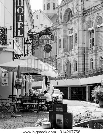 Baden-baden, Germany - Jul 7, 2019: Outdoor Terrace With Customers People At The Hotel With Bader Ta