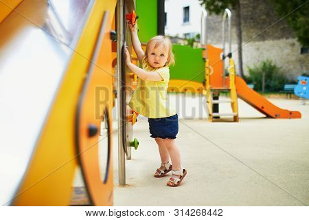 Adorable Toddler Girl Near Playground Slide. Outdoor Activities For Kids