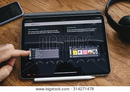 Paris, France - Jun 6, 2019: Man Reading On Apple Ipad Pro Tablet About Latest Announcement Of At Ap