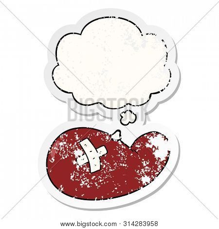 cartoon injured gall bladder with thought bubble as a distressed worn sticker