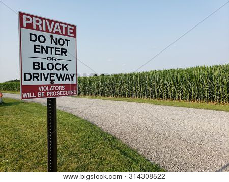 Sign at privare road entrance reading near corn field, Private Do Not Enter or Block Driveway