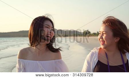 Young Asian Lesbian Couple Walking On Beach. Beautiful Women Friends Happy Relax Walking On Beach Ne