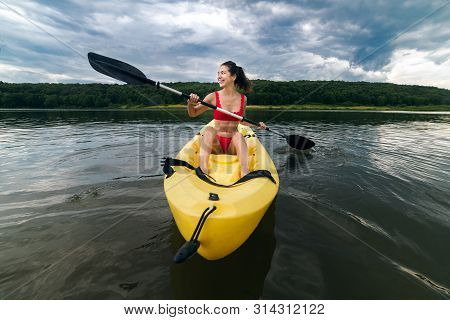 Happy Woman Enjoy Paddeling On Kayak Boat On A Forest Lake