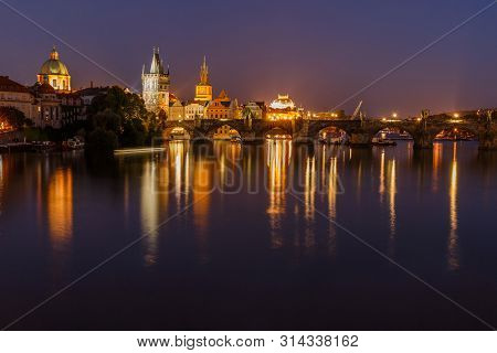 Charles Bridge Between Districts Old Town And Lesser Town At Night In Prague. Old Town Tower And His