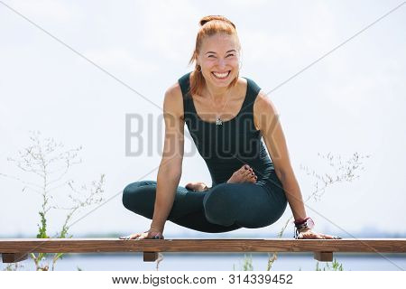 Picture Of Young Fitness Lady Outdoors In The Beach Make Yoga Stretching Exercises.