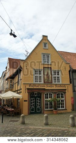 Bremen, Germany - 07 23 2015 - Scenic View Of Medieval Street Schnoor With Yellow House In The Centr