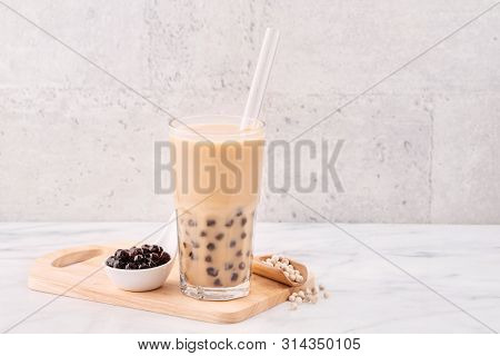 Tapioca Pearl Ball Bubble Milk Tea, Popular Taiwan Drink, In Drinking Glass With Straw On Marble Whi