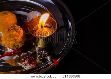 Indian Festival - Beautiful Rakhi With Rice Grains, Kumkum, Sweets And Diya On A Plate. A Traditiona