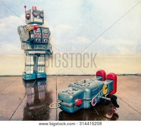 shot down concept with retro tobot toys on a wooden floor with reflection