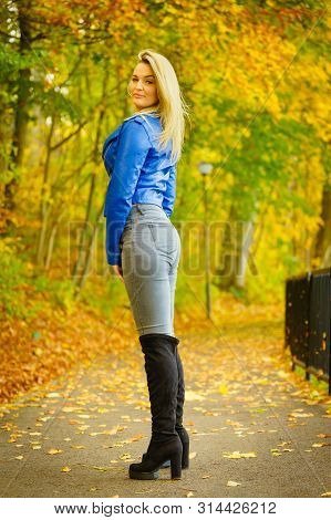 Sensual Woman Wearing Fashionable Outfit. Female Having Navy Bue Leather Jacket, Jeans And High Knee