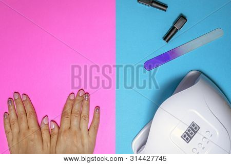 A Young Woman Manicured Hands After Procedure. Pretty Girl Using Shellac Uv Led Lamp. Concept Of Nai