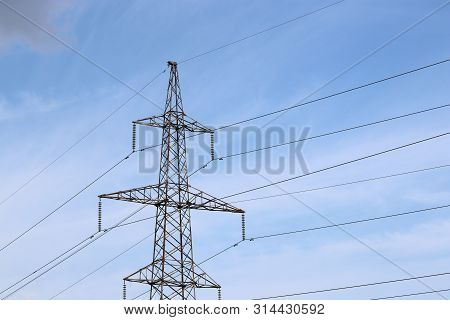 High Voltage Power Line Support With Electrical Wires On Cloudy Sky. Electricity Transmission Lines,
