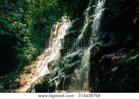 Kanto Lampo Waterfall Gianyar Bali - Scenic, Seasonal Waterfall Cascading Down A Stepped Rock Wall