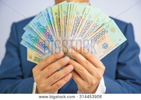 Money In Vietnam Hold On Hand Business Man Wearing A Blue Suit (socialist Republic Of Vietnam), Dong
