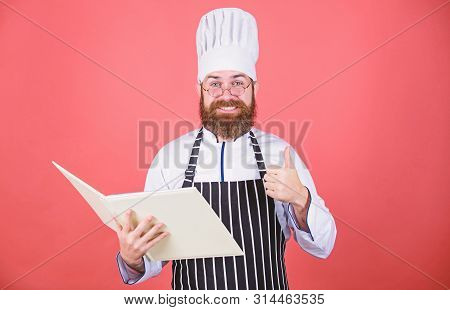 Improve Cooking Skill. Book Recipes. According To Recipe. Man Bearded Chef Cooking Food. Culinary Ar