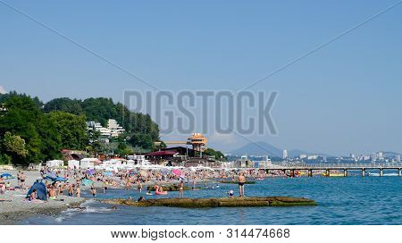 Sochi, Russia - July 7, 2019: People On The Beach Of Dagomys On A Sunny Day
