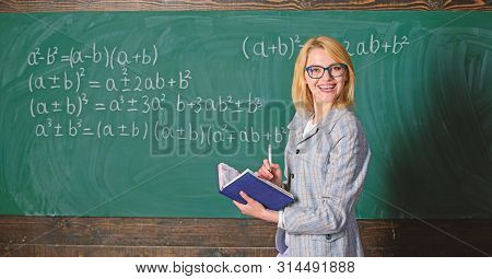 Effective Teaching Involve Acquiring Relevant Knowledge. Woman Teaching Near Chalkboard In Classroom