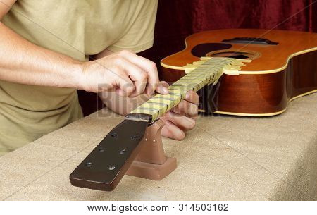Musical Instrument Guitar Repair And Service - Worker Polishing Guitar Neck Frets Acoustic Guitar Sa