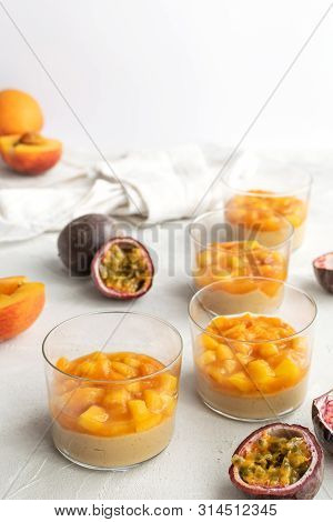 Caramel Panna Cotta, Custard Pudding With Peach And Passion Fruit, White Table, Copy Space