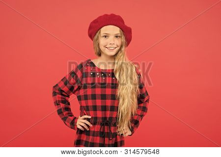 Wear Beret Like Fashion Girl. Kid Little Cute Girl With Long Blonde Hair Posing In Beret Hat And Che