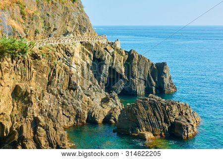 Rocky coast near Riomaggiore with the Love Road (Via dell'Amore) in Cinque Terre, Italy. 