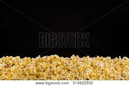 Scattered Popcorn Isolated On A Black Background