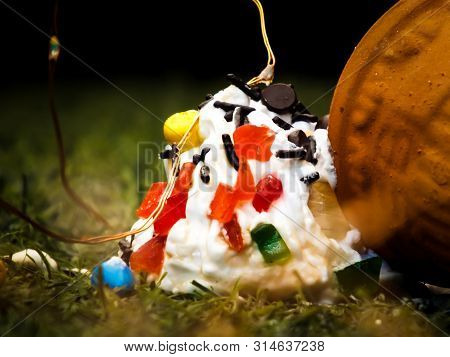 A Tasty Ice Cream On Grass With Chocolate On Top