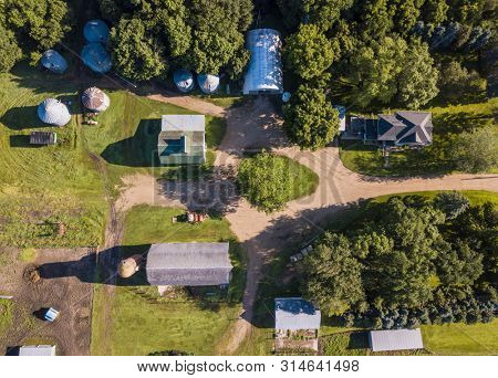 Aerial straight down view of farm house and barns on agricultural acrage and farm.